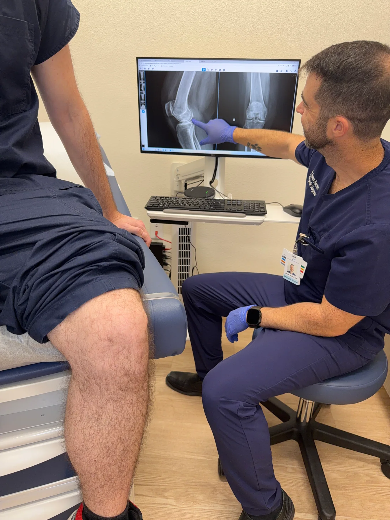 Dr. Barnes reviewing knee X-rays during a consultation