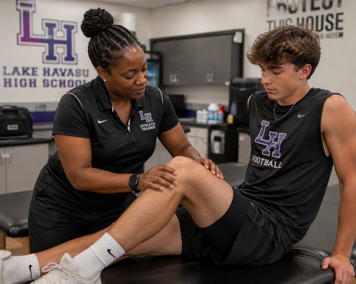 Lake Havasu High School athletic trainer evaluating an athlete's knee
